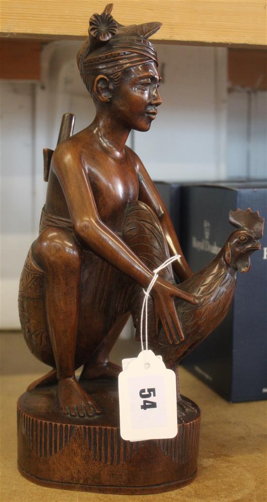 Hardwood figure with cockerel(-)